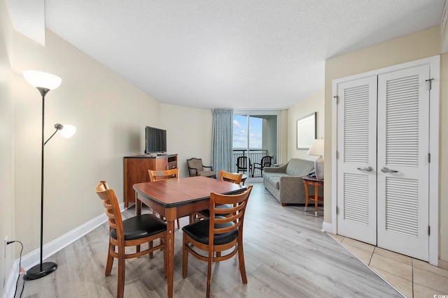 201 S Ocean Blvd Unit 1005, Myrtle Beach, SC 29577 - dining area with baseboards and light wood-style flooring