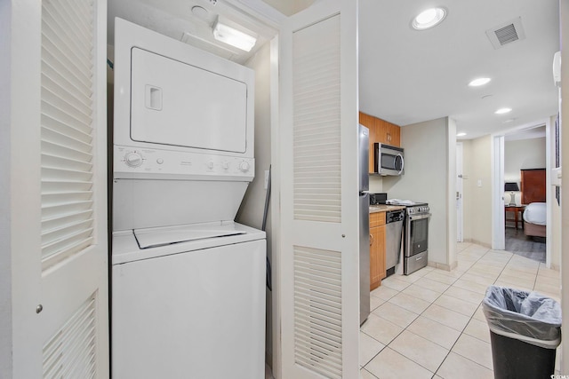 201 S Ocean Blvd Unit 1005, Myrtle Beach, SC 29577 - laundry room with laundry area, stacked washing maching and dryer, recessed lighting, light tile patterned floors, and visible vents
