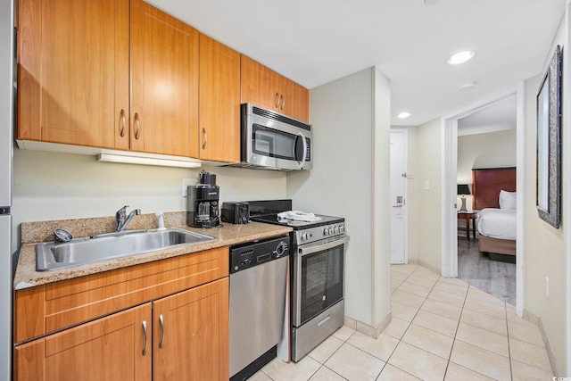 201 S Ocean Blvd Unit 1005, Myrtle Beach, SC 29577 - kitchen with a sink, stainless steel appliances, baseboards, recessed lighting, and light tile patterned floors