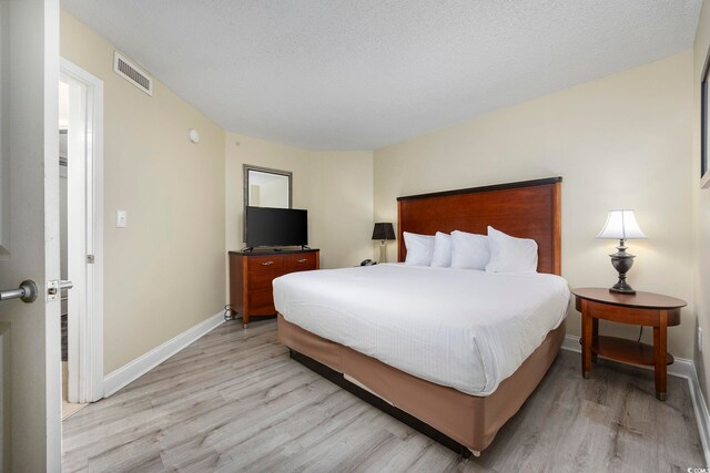 201 S Ocean Blvd Unit 1005, Myrtle Beach, SC 29577 - bedroom featuring baseboards, visible vents, and light wood-style flooring