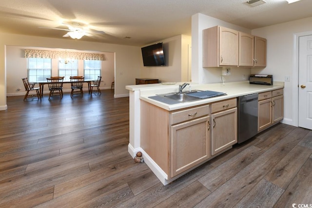 kitchen with stainless steel dishwasher, light brown cabinets, sink, dark hardwood / wood-style floors, and kitchen peninsula