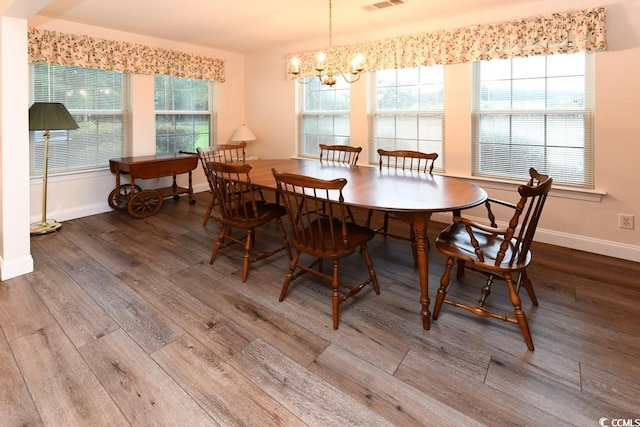 dining area with a chandelier, hardwood / wood-style flooring, and a wealth of natural light