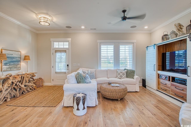 living area featuring visible vents, crown molding, baseboards, and hardwood / wood-style floors