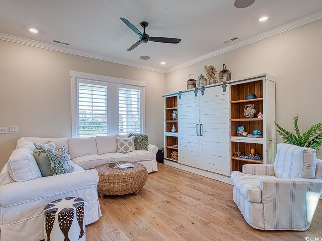 living room featuring ceiling fan, crown molding, and light hardwood / wood-style flooring