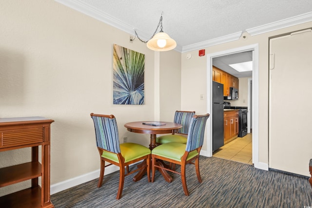 tiled dining area with a textured ceiling and crown molding