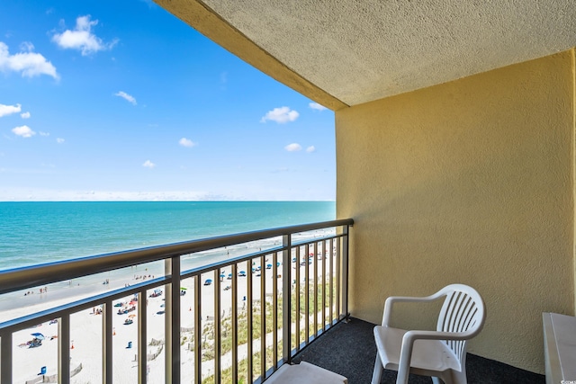 balcony with a view of the beach and a water view