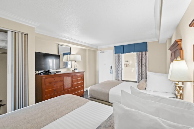 bedroom with a textured ceiling and ornamental molding