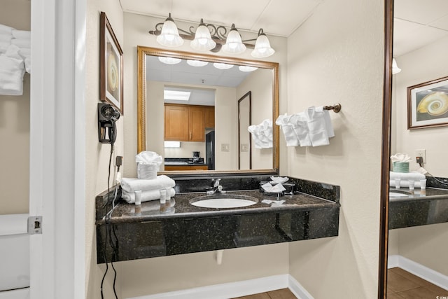 bathroom with tile patterned flooring and vanity