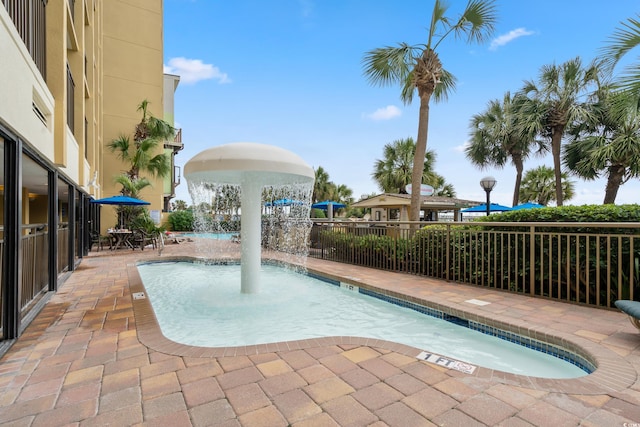 view of swimming pool with a patio area and pool water feature