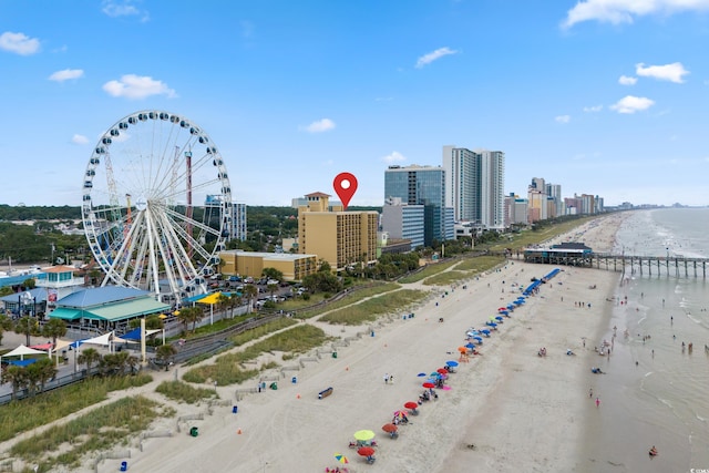 birds eye view of property featuring a water view and a beach view