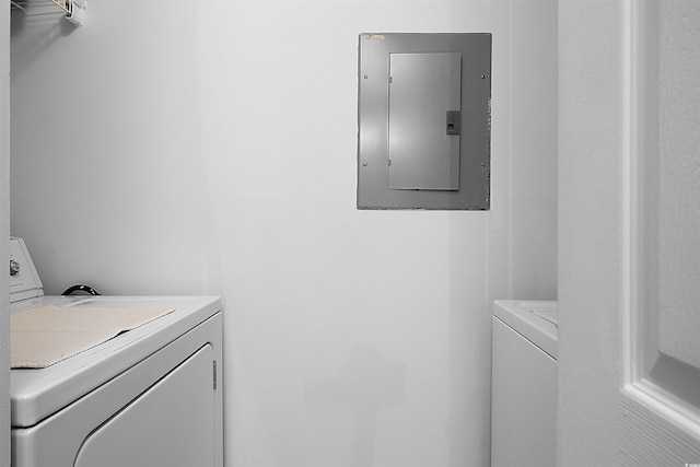 washroom featuring electric panel and washer and dryer