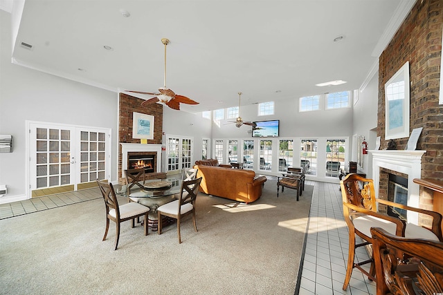 carpeted dining room featuring crown molding, french doors, and a fireplace