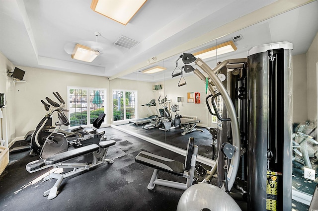 exercise room with a tray ceiling