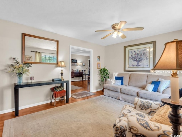 living room with hardwood / wood-style floors and ceiling fan