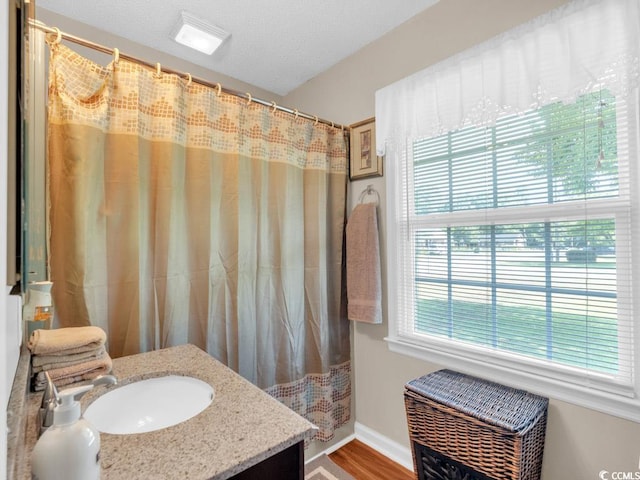 bathroom with vanity, hardwood / wood-style floors, and walk in shower