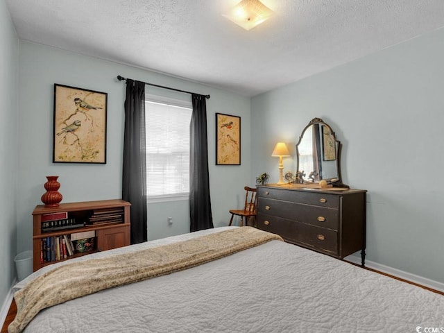 bedroom featuring wood-type flooring and a textured ceiling