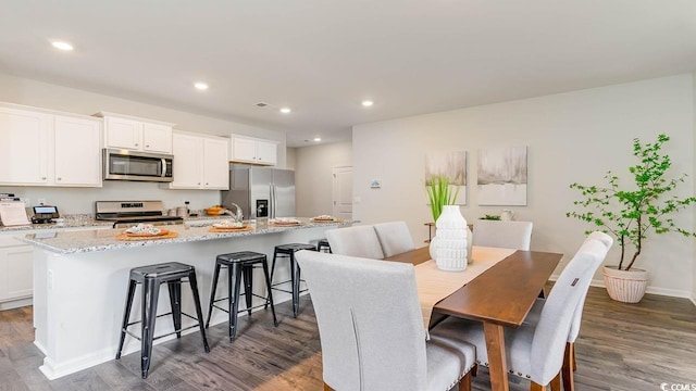 dining space with dark wood-type flooring