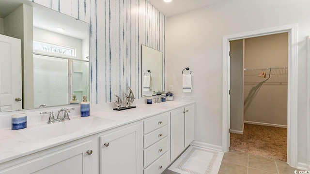 bathroom featuring tile patterned flooring and vanity