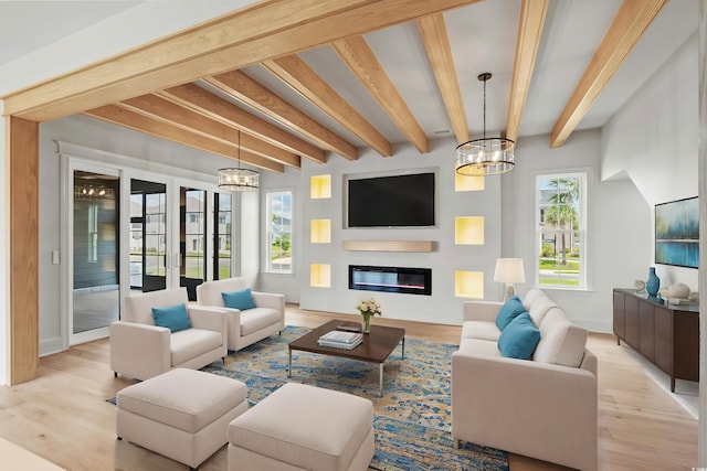 living room with a notable chandelier, light wood-type flooring, and beam ceiling