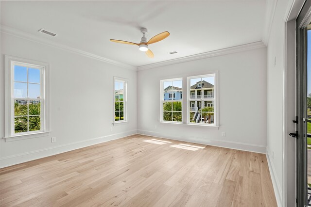 unfurnished room with plenty of natural light, ornamental molding, and light hardwood / wood-style floors