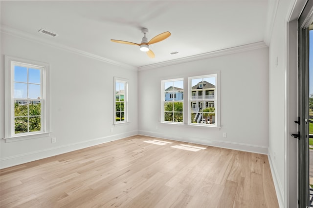 unfurnished room featuring light wood-style floors, baseboards, ornamental molding, and a ceiling fan