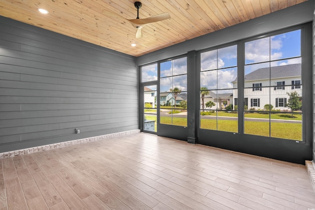 unfurnished sunroom featuring wood ceiling and a residential view