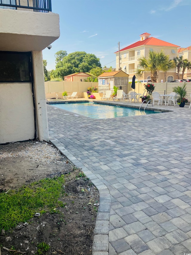 view of swimming pool featuring a patio area