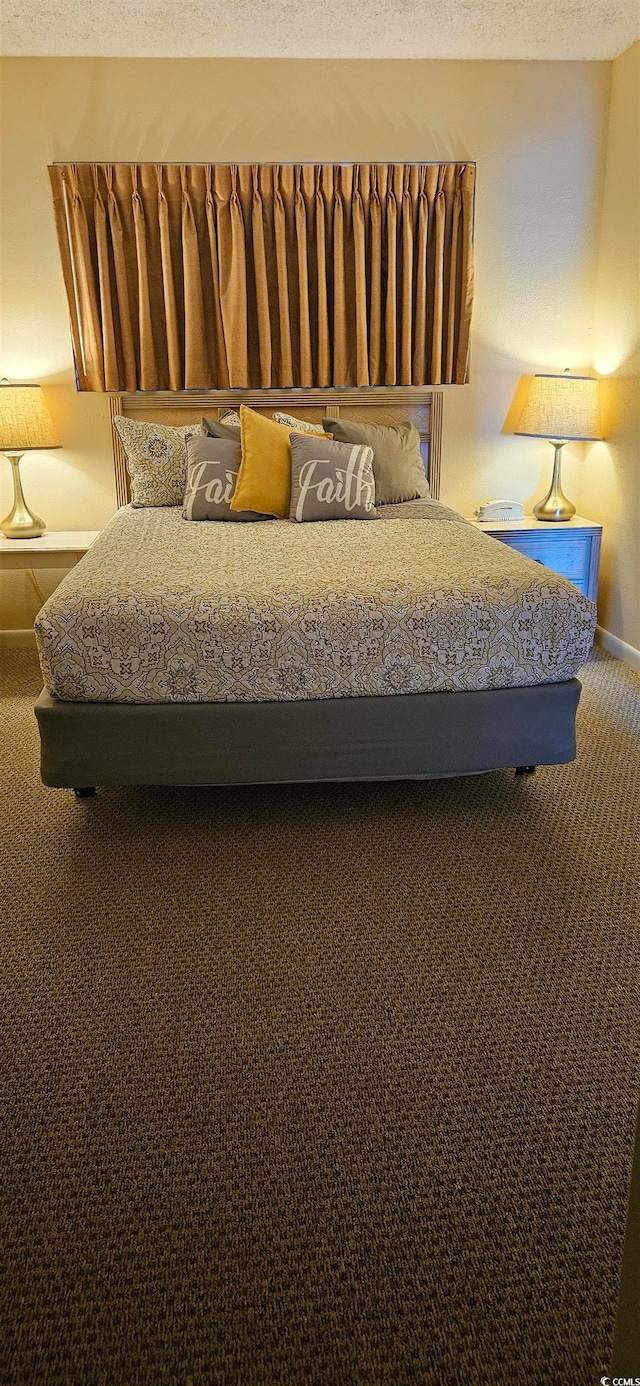 unfurnished bedroom featuring a textured ceiling and carpet