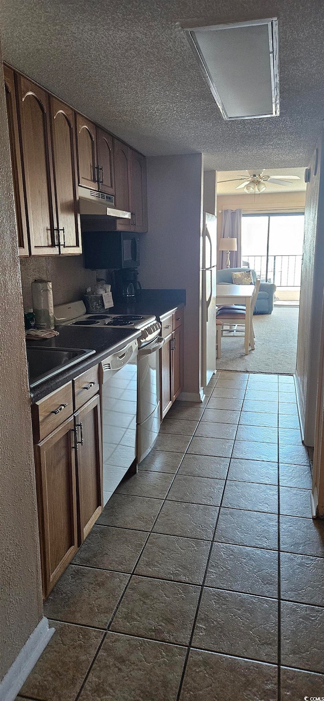 kitchen with a textured ceiling, tile patterned floors, dishwasher, ceiling fan, and refrigerator