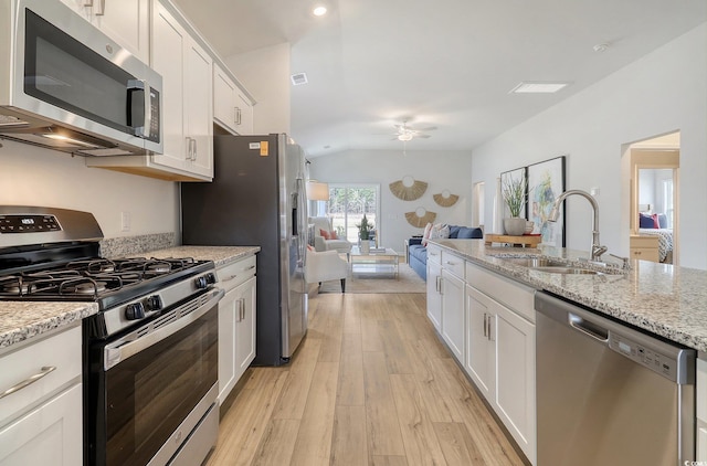 kitchen featuring appliances with stainless steel finishes, light wood-type flooring, and white cabinets