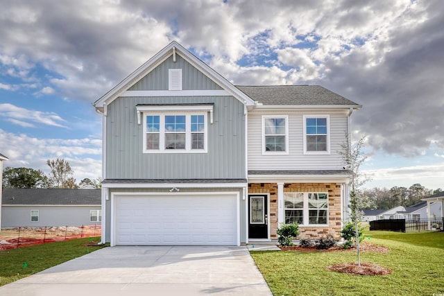 view of front of home with a front yard, concrete driveway, fence, a shingled roof, and a garage