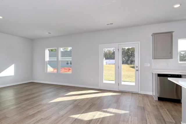 interior space with visible vents, a healthy amount of sunlight, and light wood-style floors
