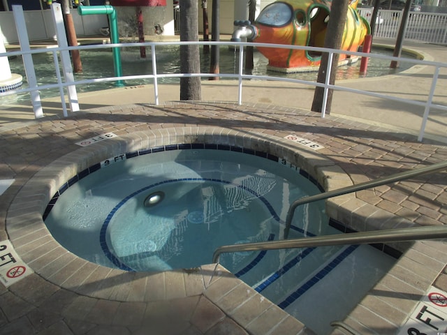 view of pool featuring a community hot tub