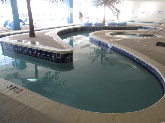 view of swimming pool featuring an indoor in ground hot tub