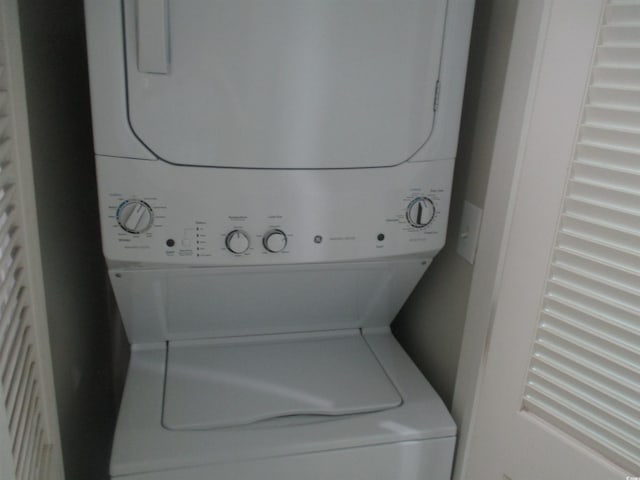 laundry area with stacked washer and dryer