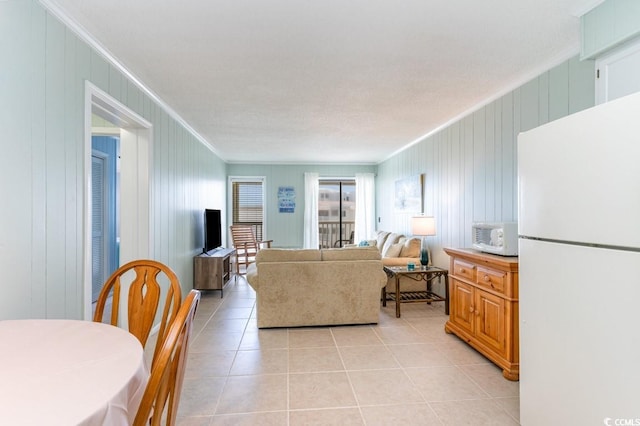 living room featuring ornamental molding and light tile patterned flooring