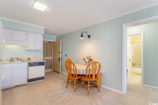 dining room with crown molding, sink, light tile patterned floors, and a textured ceiling