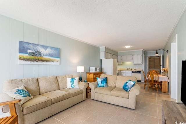 living area with light tile patterned floors, a textured ceiling, and crown molding