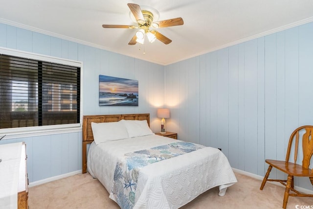 carpeted bedroom with crown molding and ceiling fan