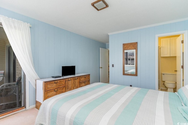 bedroom featuring light colored carpet, ensuite bath, and ornamental molding