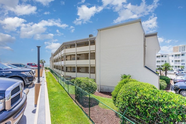 view of building exterior with fence