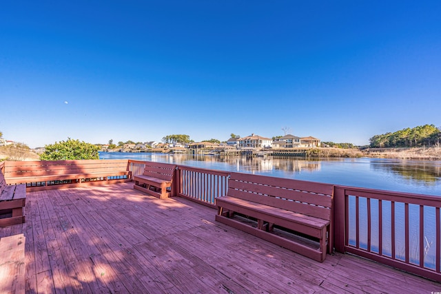 exterior space featuring a deck with water view