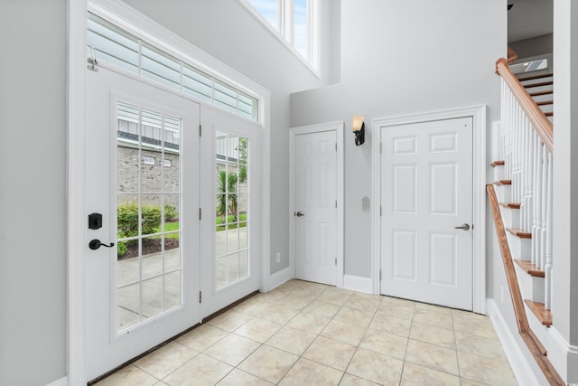 foyer with a wealth of natural light and light tile patterned flooring