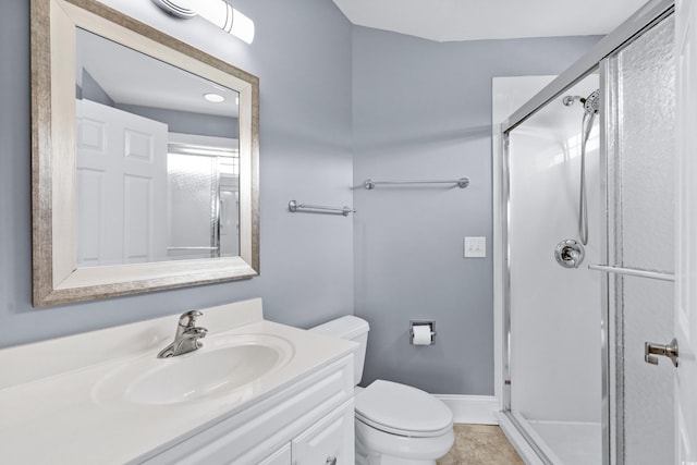 full bathroom with baseboards, a stall shower, toilet, and vanity