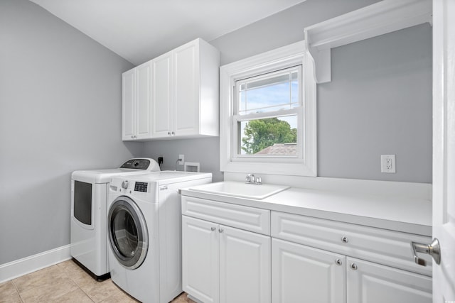 clothes washing area featuring cabinets, separate washer and dryer, sink, and light tile patterned floors