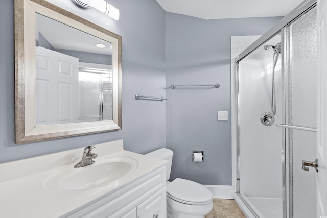 bathroom featuring vanity, toilet, and walk in shower