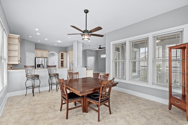 dining area with baseboards, recessed lighting, arched walkways, and a ceiling fan