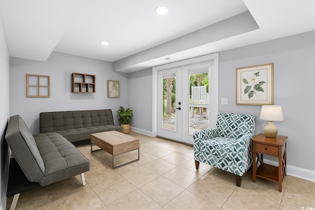 living area featuring baseboards, visible vents, light tile patterned flooring, and french doors