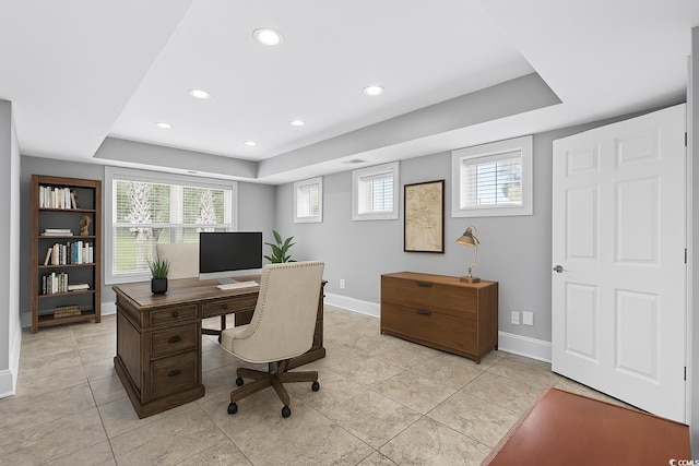 office space with light tile patterned floors, recessed lighting, a raised ceiling, and baseboards