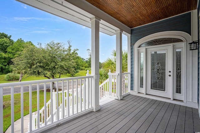 wooden deck featuring a yard